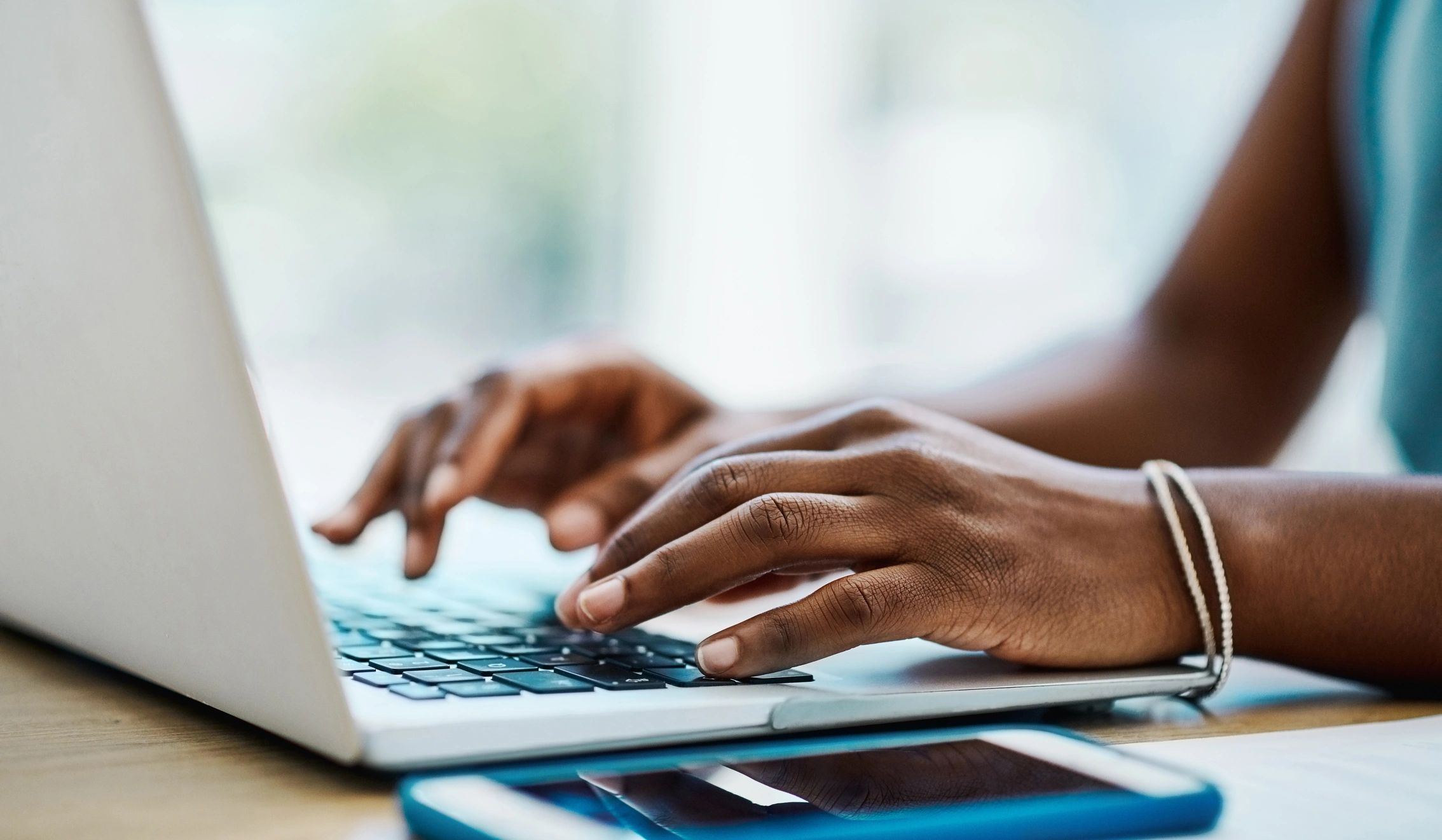 Woman typing on a laptop in an office
