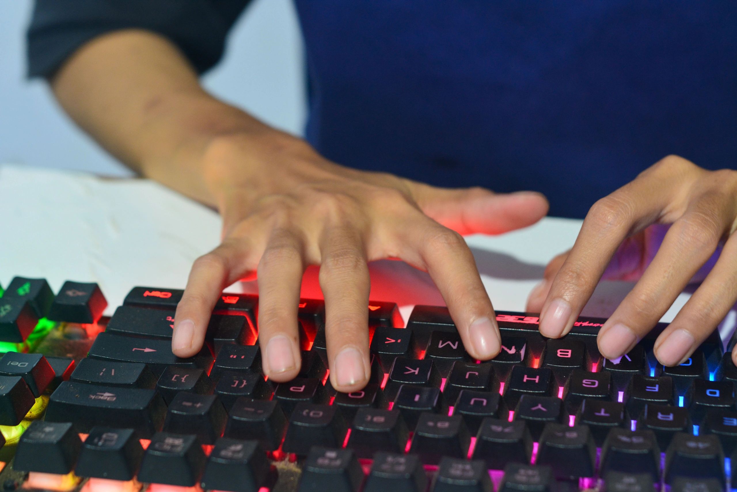 Hands typing on computer keyboard in office desk
