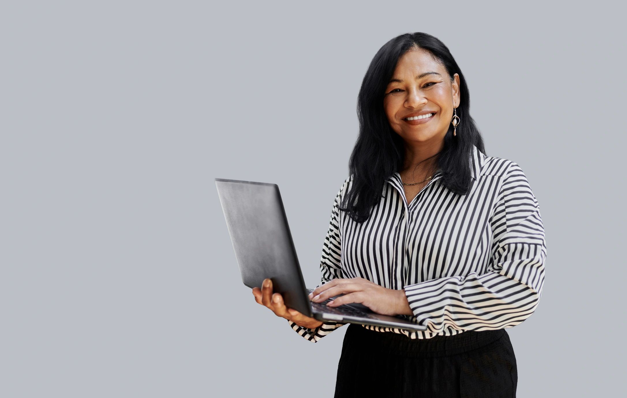 Older woman using a laptop with confidence