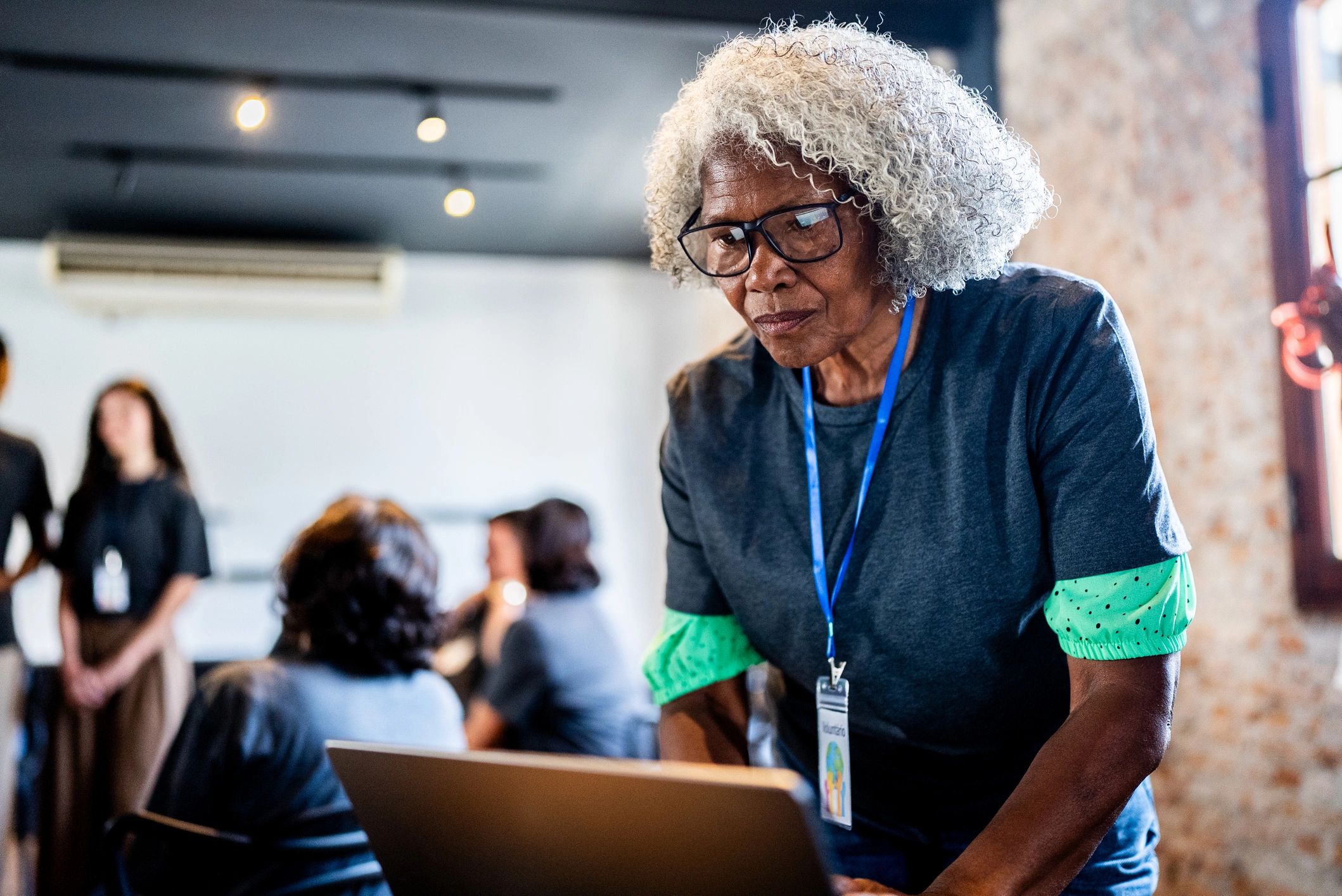 Volunteer using laptop during community outreach